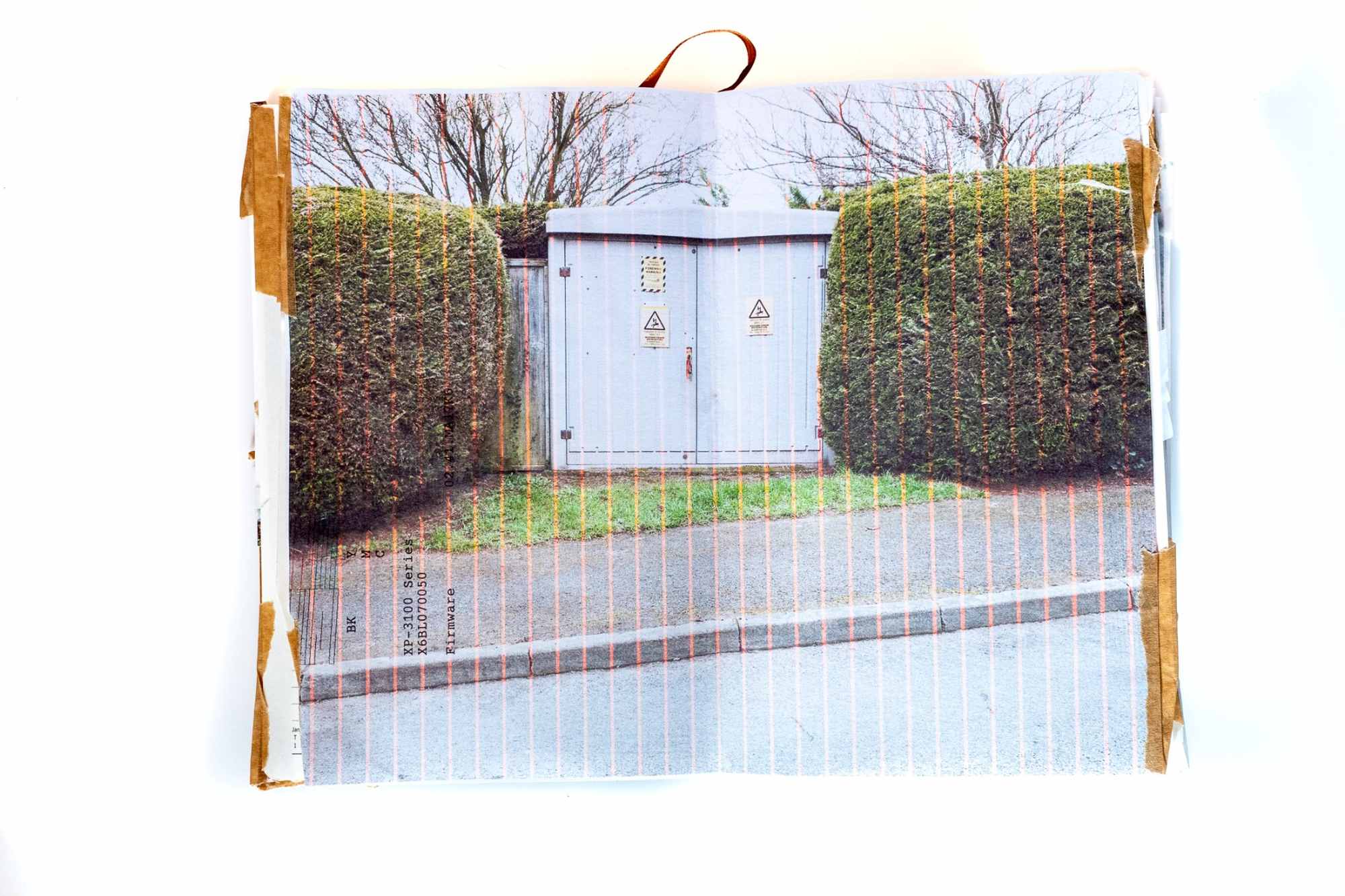 A photographic sketchbook. A substation with hedges in suburbia.